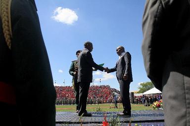 Prime Minister Mosisili receiving the instruments of power from Former Prime Minister Thabane